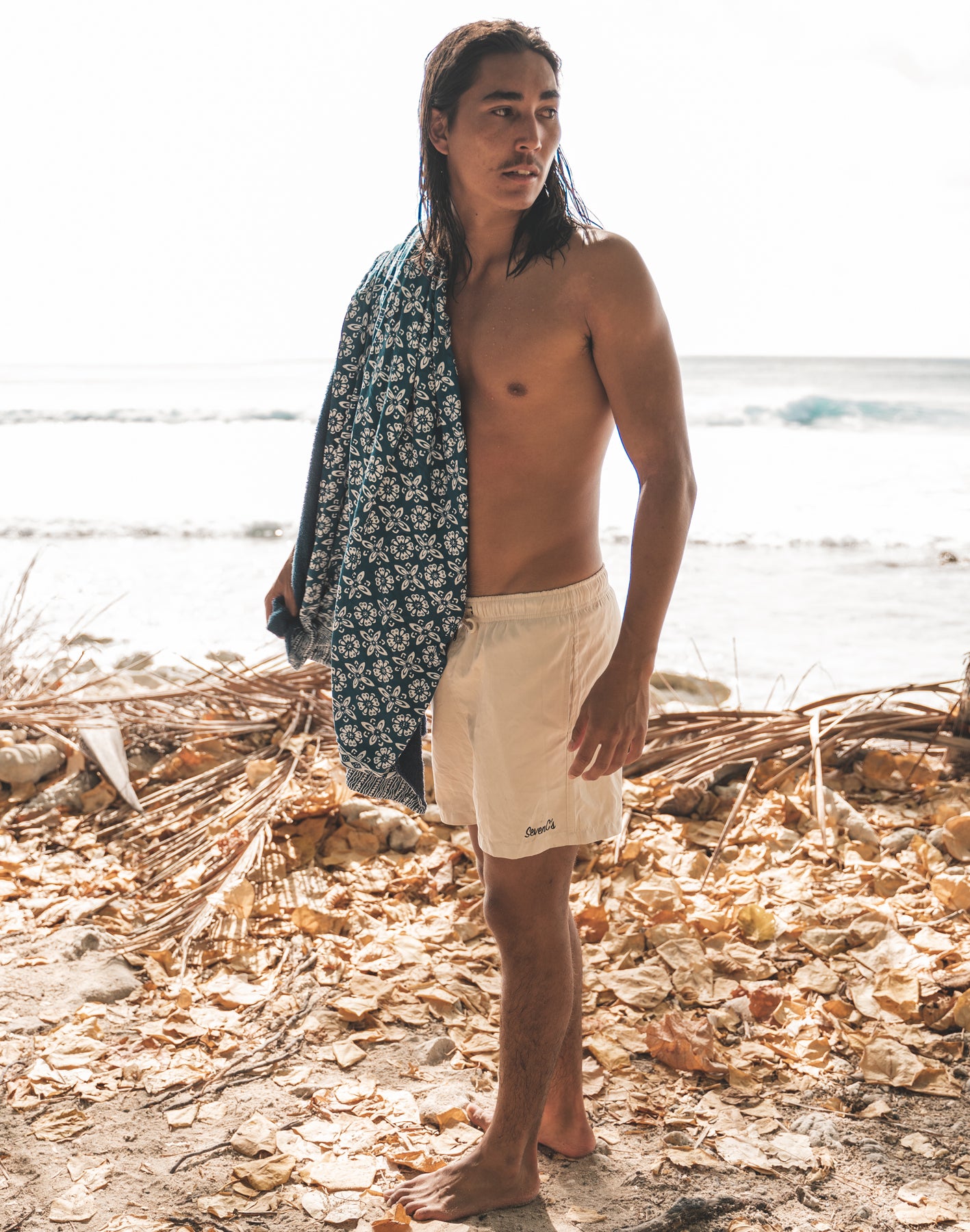 SevenCs Men's Recycled Polyester Shorts in Sand Stone - on model at beach