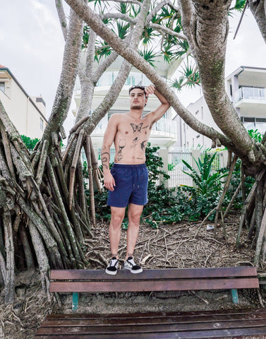 SevenC's Men's Recycled Polyester Shorts in Navy Blue - On model at beach