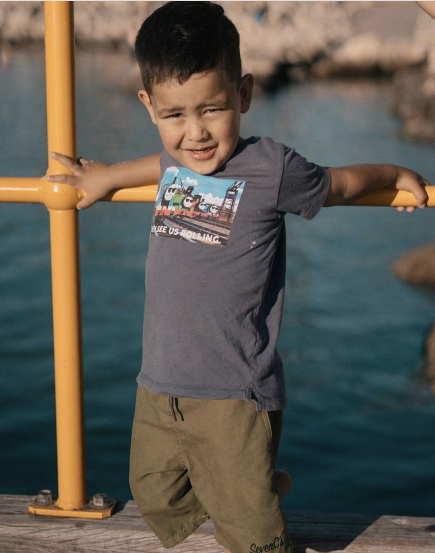  SevenC's Kids' Recycled Polyester Shorts in Olive on Kid Model at beach