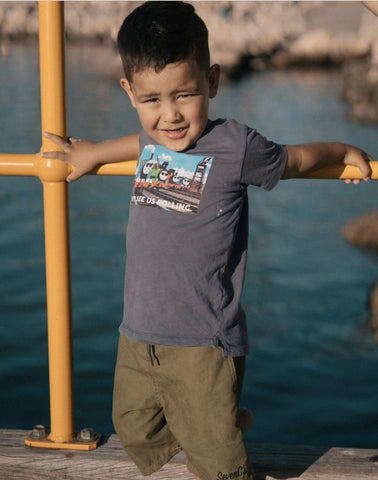  SevenC's Kids' Recycled Polyester Shorts in Olive on Kid Model at beach