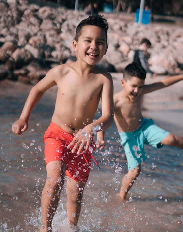 Sustainable Kids' Red Shorts from SevenC's - Running at beach 